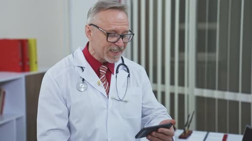 Doctor Wearing Lab Coat Talking and Using Tablet