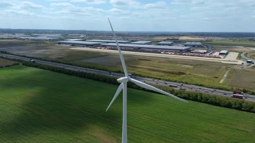 Aerial view of wind turbine near highway, United Kingdom.
