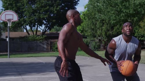 One on One Street Basketball; Player Goes in for Lay Up Action