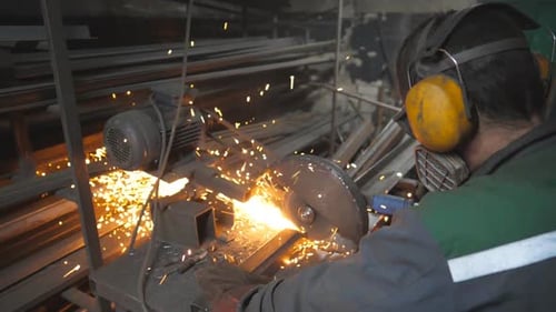 Man Using Chop Saw Cutting Metal with Sparks