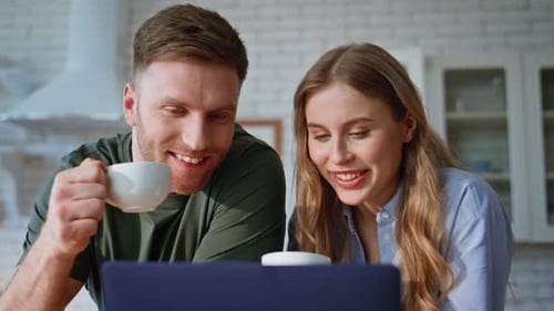 Happy Couple Laughing Together in Their Kitchen