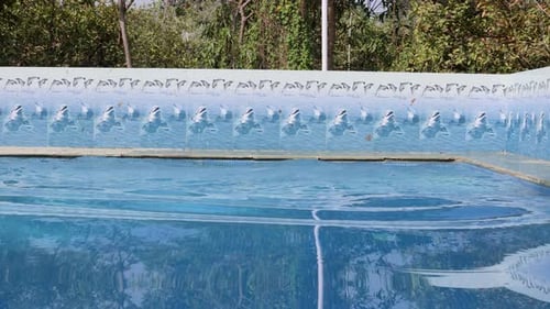 isolated swimming pool with clear water ripples at morning