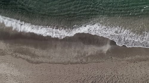 Top down view of waves on the beach