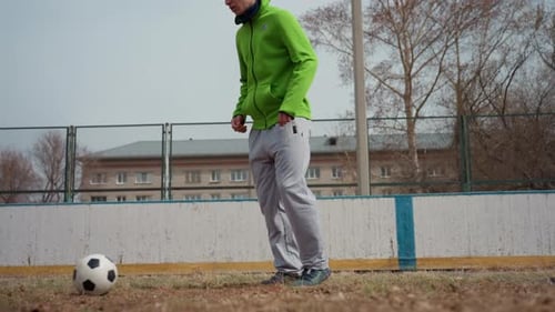 Lowangle Closeup of White Male Controlling and Passing Soccer Ball Soft Autumn Light on Fenced Field