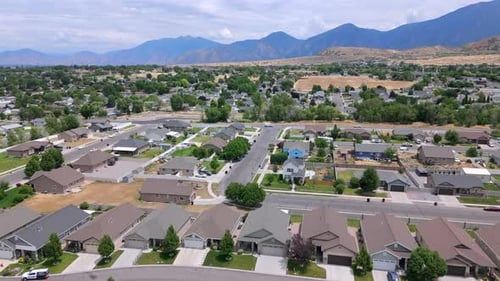 A Beautiful Aerial View of a Suburban Neighborhood Surrounded By a Scenic Mountain Background