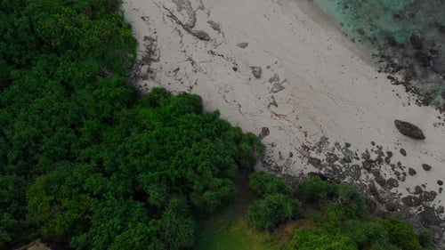 Aerial view of sandy beach and ocean with cliffs, Indonesia.