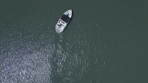 Aerial view of a wakeboarding sport boat practice on the lake with calm water