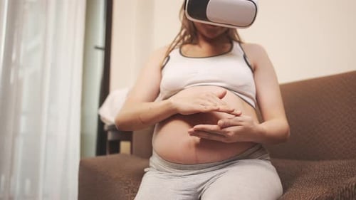 Pregnant Woman Using VR Headset at Home