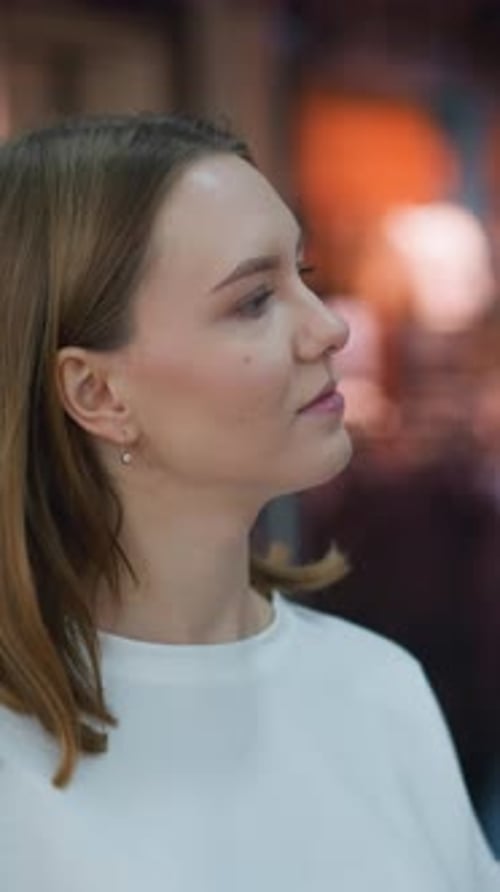 Woman Looking at Clothing Store Display in Modern Retail Mall Setting