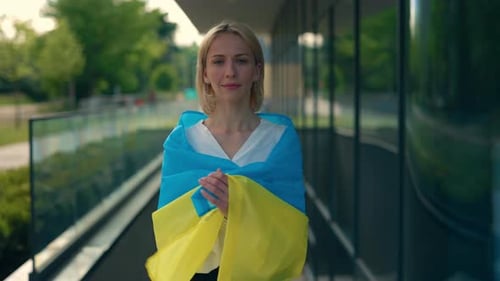 Woman Holding Flag Outside Modern Building