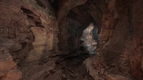 Exploring the Rugged Interior of a Cave with Dramatic Rock Formations at Dusk