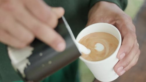 Pouring Cream Into Cappuccino Glass Making A Beautiful Coffee Art - close up, slow motion