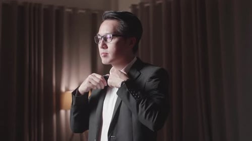 Dapper Man Adjusts Bow Tie Before Evening Event