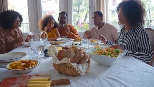 Family and Friends Eating Meal Together at Home