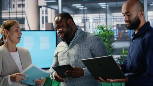 Business Professionals Discussing Company Data in Modern Office