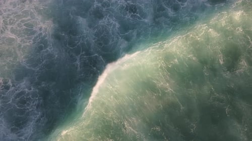 Top view of beautiful wave and soft foam texture in turquoise sea water at sunset. Relaxing Backgrou