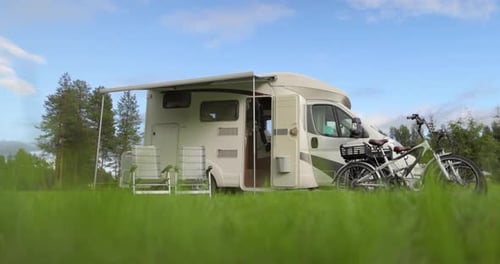 Camper Parked in Grassy Field with Bicycles