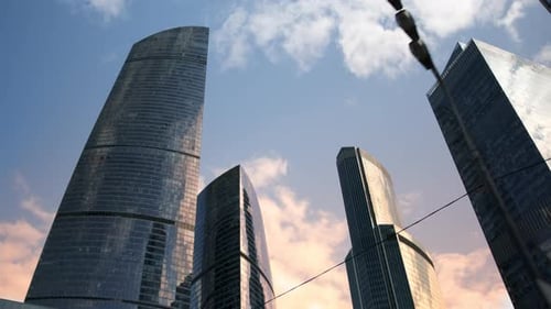 Bottomup View of Huge Mirrored Skyscraperers Against Sunset Sky Business Offices in Large Building