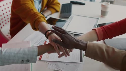 Unrecognizable Diverse Team Members Joining Hands after Meeting
