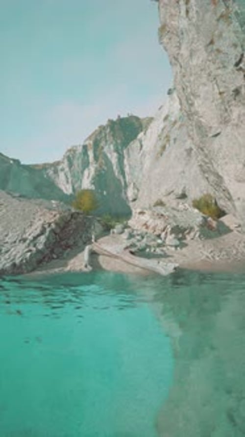 Rocky Waterfront With Mountain Background