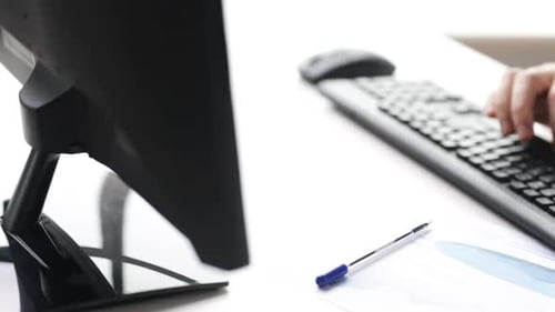 Man Typing on Keyboard at Office Desk