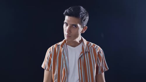 Psychologically troubled man looking strangely at camera.