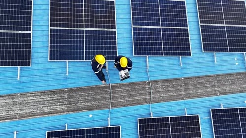 Aerial view of solar photo voltaic panels system on building roof. Renewable ecological green energy