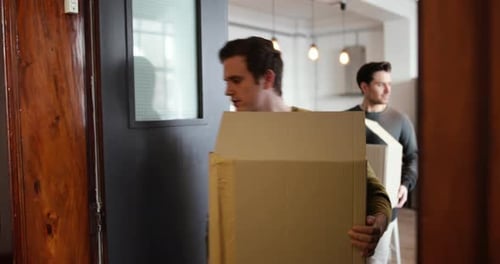 Young male couple moving home