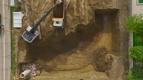 Aerial View of Excavator Digging at Construction Site