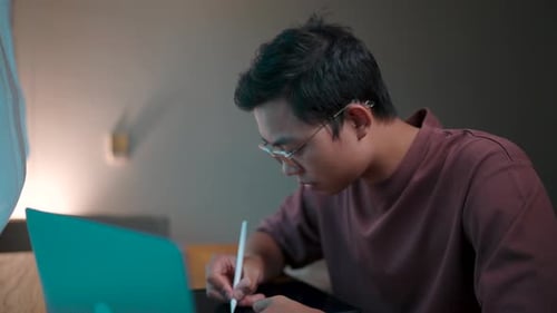 Young Man Using a Digital Pen on a Tablet
