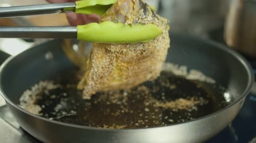 Close Up of Fried Fish Cooking in Pan