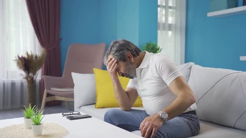 Man Sitting on Couch with Chest Discomfort