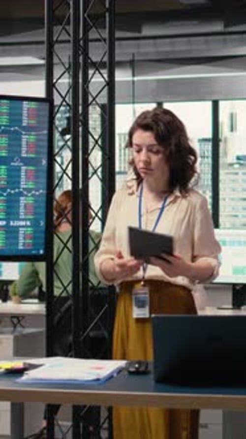 Vertical Video Female Administrator Reviewing the Performance Numbers of Her Team