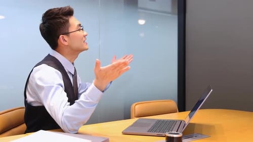 Excited Young Adult Man Celebrates Success in Office