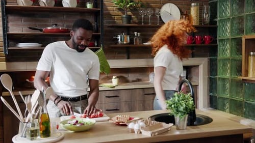 Couple Cooking Together in a Sunny Kitchen