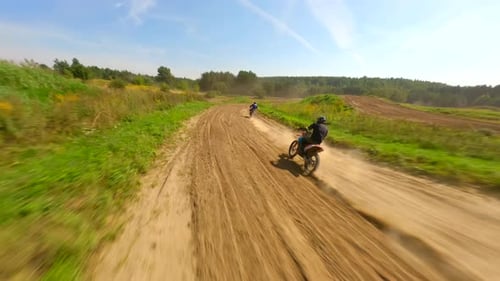 Dirt Bikes Racing on Rural Track on Sunny Day