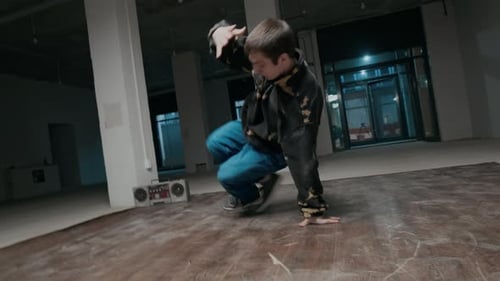 Inspired Gen Z B-Boy Performing Down Rock while Breaking Indoors
