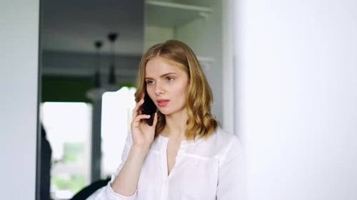 Beautiful Girl Talking on Smartphone. Serious Young Woman Discussing on Phone. Close