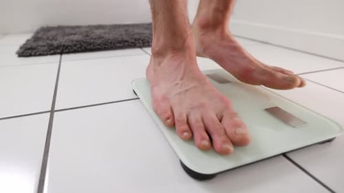 Man Checking Weight Bathroom Scale