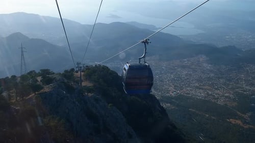 Cable Cars Ascending Scenic Mountain with City View