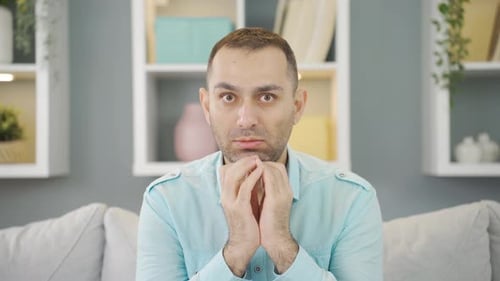 Psychologically troubled man looking strangely at camera.