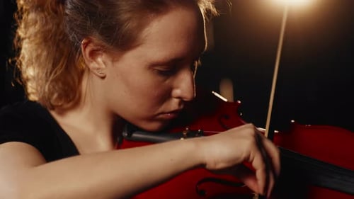 Beautiful Caucasian Woman Playing Violin in Dark Studio Enjoy Classical Music Portrait of Inspired