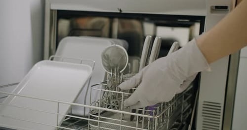 Medical Instruments Being Loaded Into Sterilizing Machine