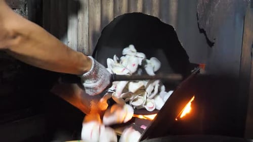 The traditional production method for the popular Krupuk snack in Indonesia uses black sand for fryi