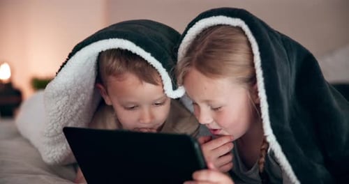 Children Under Blanket Watching Tablet at Home