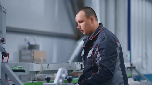 Professional Engineer Programming CNC Machine in Modern Workshop of Plant with New Equipment