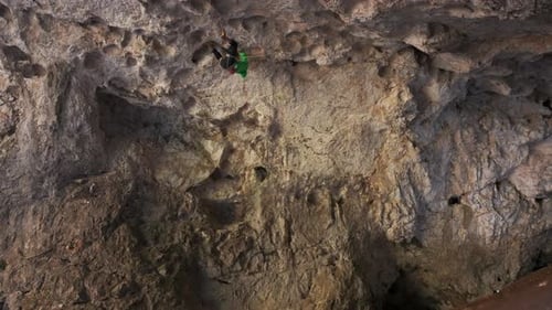 Man Climbing Up Cliff Face