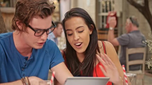 University students study together with technology in a relaxed cafe environment