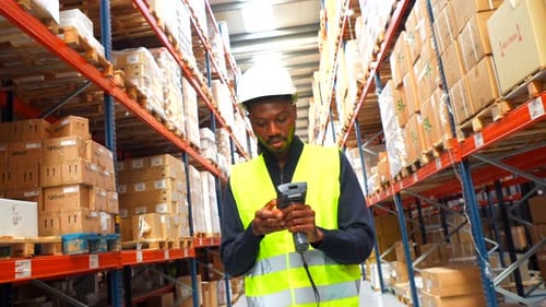 Warehouse Worker Scanning Packages with Barcode Scanner