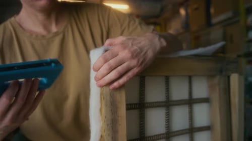 Woman Upholstering Furniture with Staple Gun